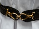 a black belt with gold buckles on a white dress
