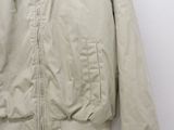 jacket hanging on a hanger on a wall with a white background
