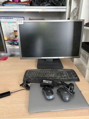 a desk with a keyboard, mouse, and monitor on it