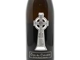 a bottle of wine that has a cross on it