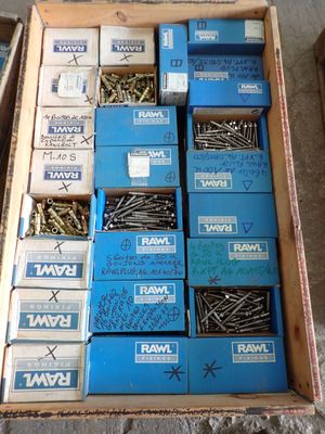 many boxes of screws in a box on the floor