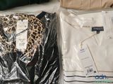 two shirts and a handbag on a table