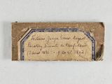 an old piece of paper with writing on it sitting on a table