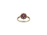 a close up of a gold ring with a pink stone