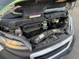 a car with its hood open and the engine in the trunk