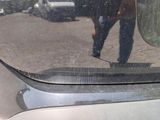 a reflection of a man in a mirror on the side of a car
