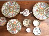many plates and bowls sitting on a wooden table