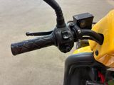 a close up of the handlebars on a yellow motorcycle
