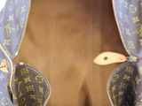 a blue bag with a handle that has a duck on it