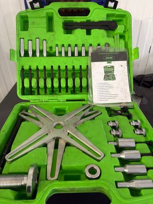 a green case with tools in it on a table