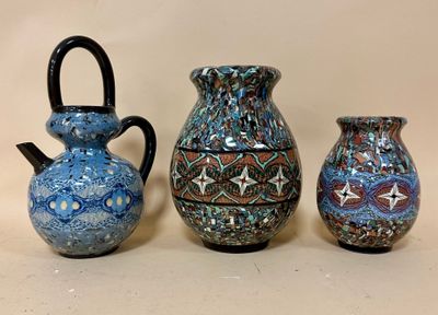 three vases are sitting next to each other on a table