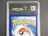 the pokemon card is in a plastic case on a table
