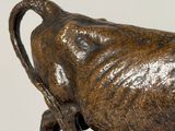 a statue of a bull that is standing on a rock