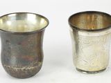 two cups sitting next to each other on a white surface
