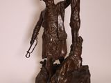 bronze statue of a man with a gun and a dog