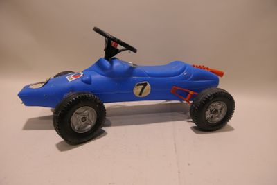a blue toy car with a steering on a white surface