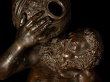 bronze statue of a woman holding a baby in her arms