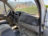 the interior of a truck with the door open and the driver ' s seat down
