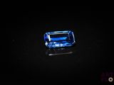 a blue sapphire stone on a black surface