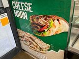 a sign that says cheese nian on the side of the counter