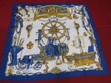 blue and white scarf with a picture of a ship, a wheel, and other items