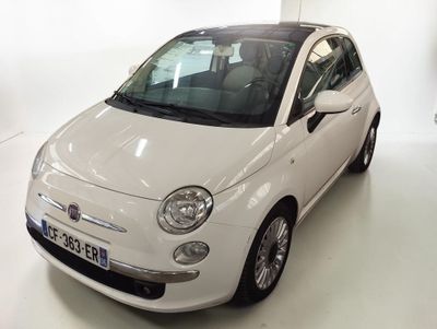 a small white car that is parked in a room