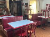 a red and blue table and chairs in a room