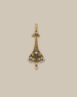 a gold and pearl pendant with a cross on it