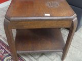 a small wooden table with a small shelf on it