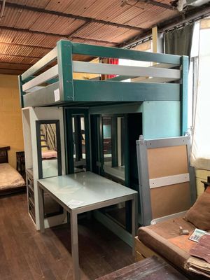 un lit superposé avec un bureau en dessous, dans une chambre