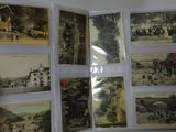a person holding a book with a bunch of old photos on it