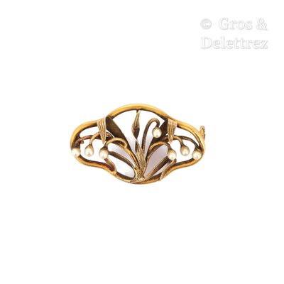 an image of a gold ring with a flower design on it