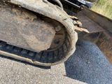 a bulldozer that is parked on the side of the road