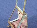 a small glass box with a mirror on it