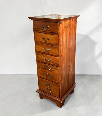 a wooden chest of drawers with four drawers on each side