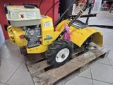 a small yellow machine that is sitting on a pallet