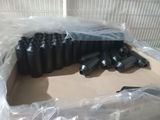 many black bottles in a box on a table