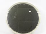 an image of a small round mirror on a white surface
