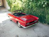 a red convertible car parked on the side of the road