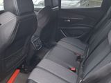 the back seats of a black car are empty and the seats are empty