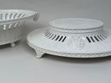 two white baskets that are sitting on a table