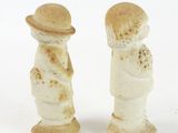 two figurines that are standing next to each other