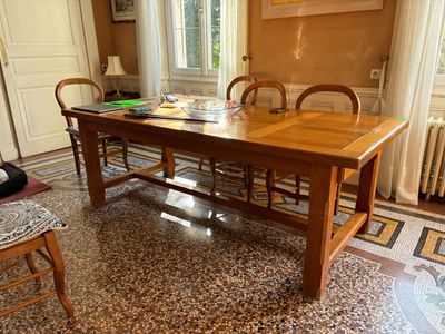 a wooden table and chairs in the middle of a room