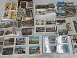 a lot of postcards on a table with a box of them