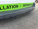 a green and black sign on the side of a white van
