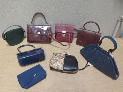 de nombreux sacs à main différents, tous posés ensemble sur la table