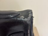 a black purse sitting on top of a stack of boxes