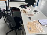 a desk with a chair and a computer on it in a warehouse