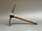 a hammer with a wooden handle on a gray surface