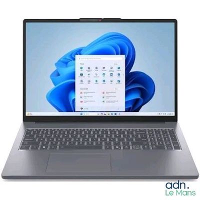the laptop is open on a white background with a blue flower